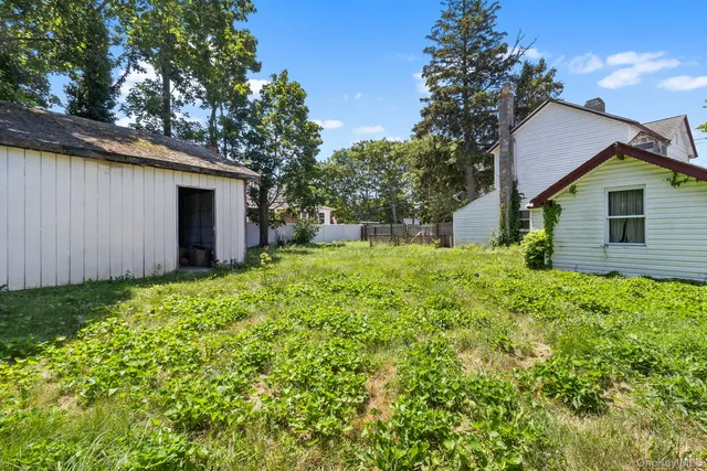 a view of a house with yard and a garden