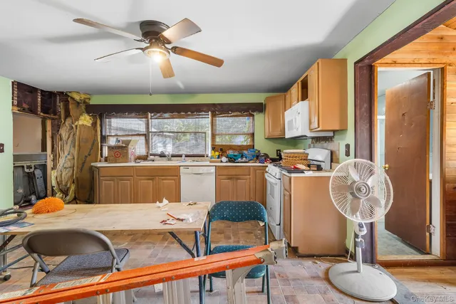 a room with table chairs and a chandelier