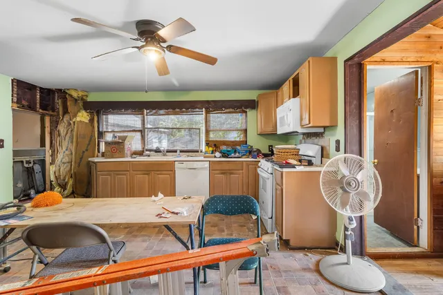 a room with table chairs and a chandelier