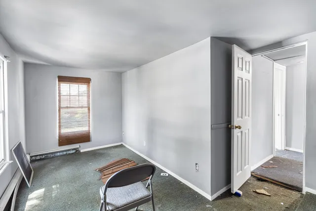 a view of room with window and hallway