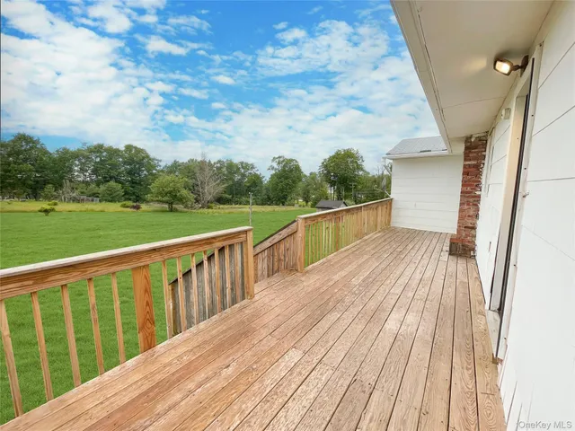 a view of balcony with wooden floor and fence