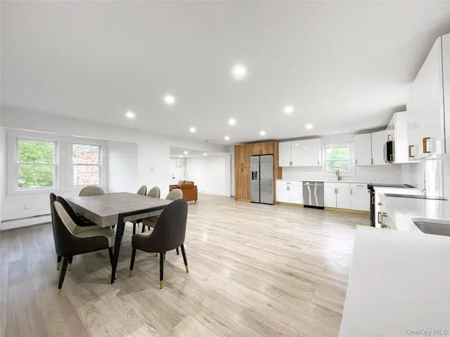 a view of a dining room with furniture and a kitchen