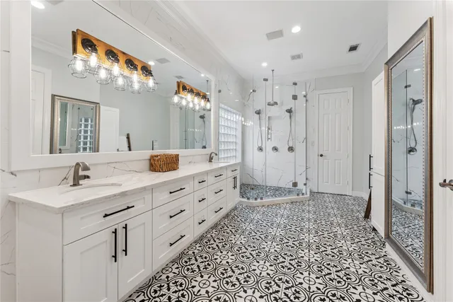 a spacious bathroom with a double vanity sink mirror and bathtub