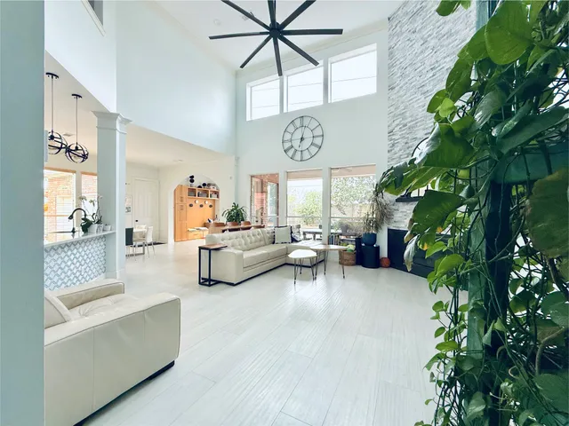 a living room with furniture and a potted plant