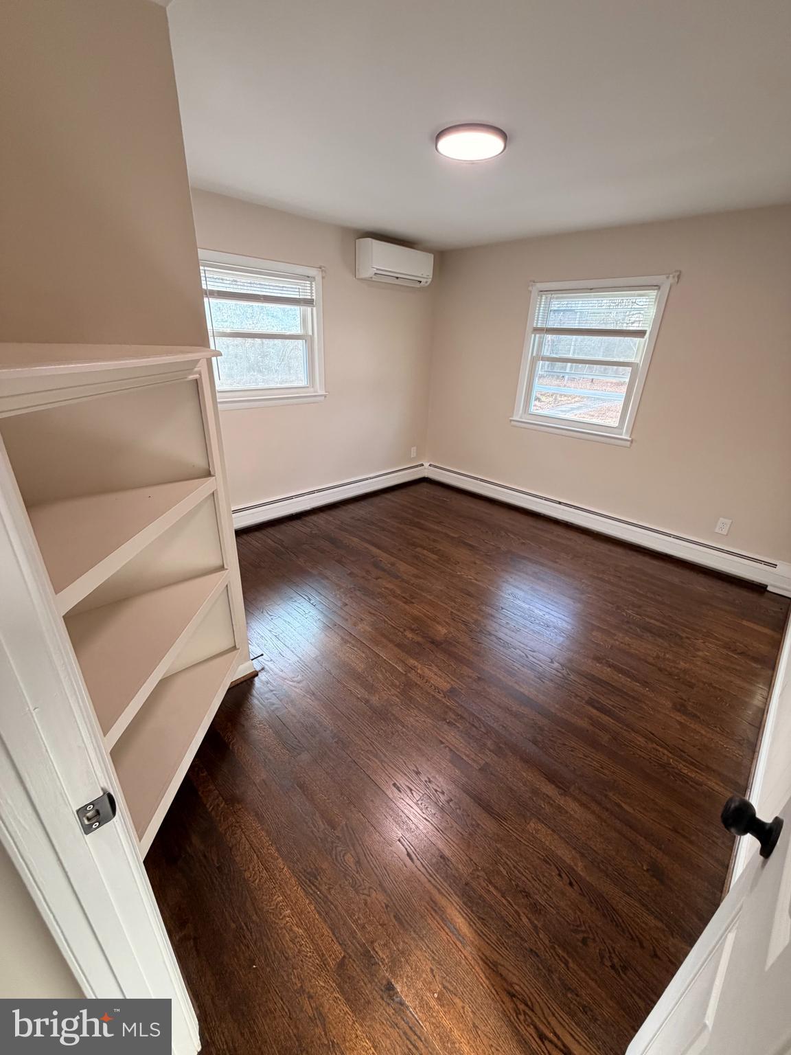 21184 Colton Point Road Avenue, MD 20609 - Photo 11 of 20 an empty room with wooden floor and windows