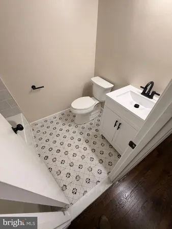 a bathroom with a sink toilet and a mirror