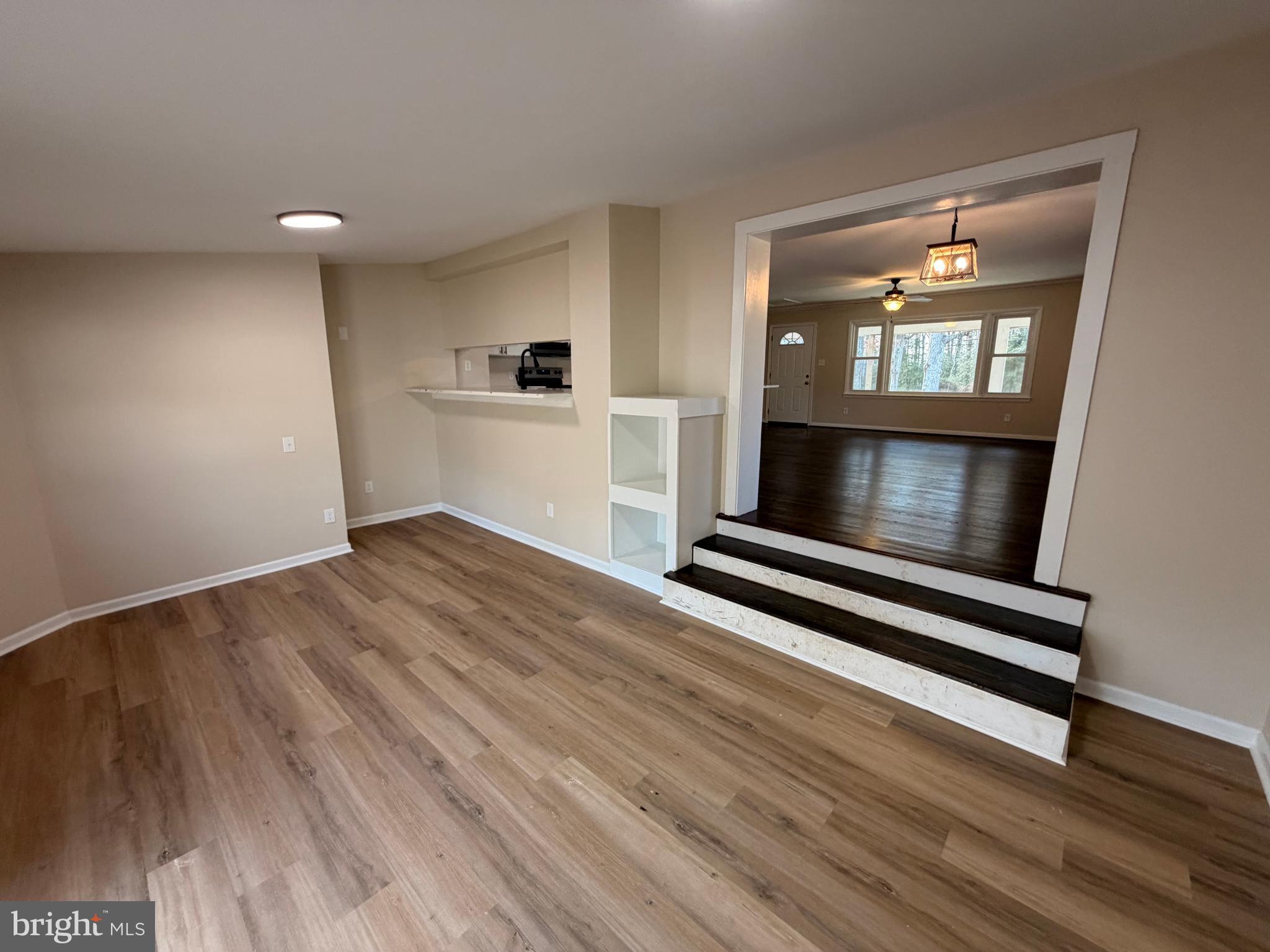 21184 Colton Point Road Avenue, MD 20609 - Photo 6 of 20 a view of wooden floor fire place and windows in a room