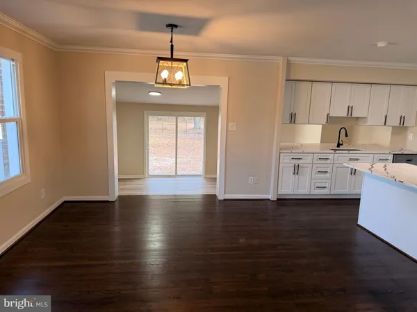 a view of a kitchen with a dishwasher wooden floor and a window