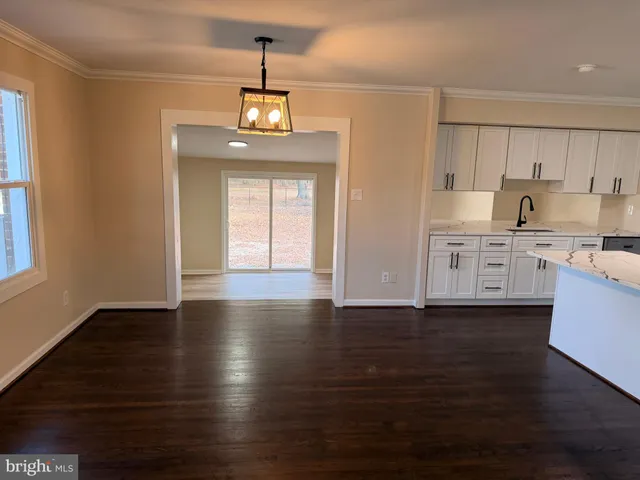 a view of a kitchen with a dishwasher wooden floor and a window