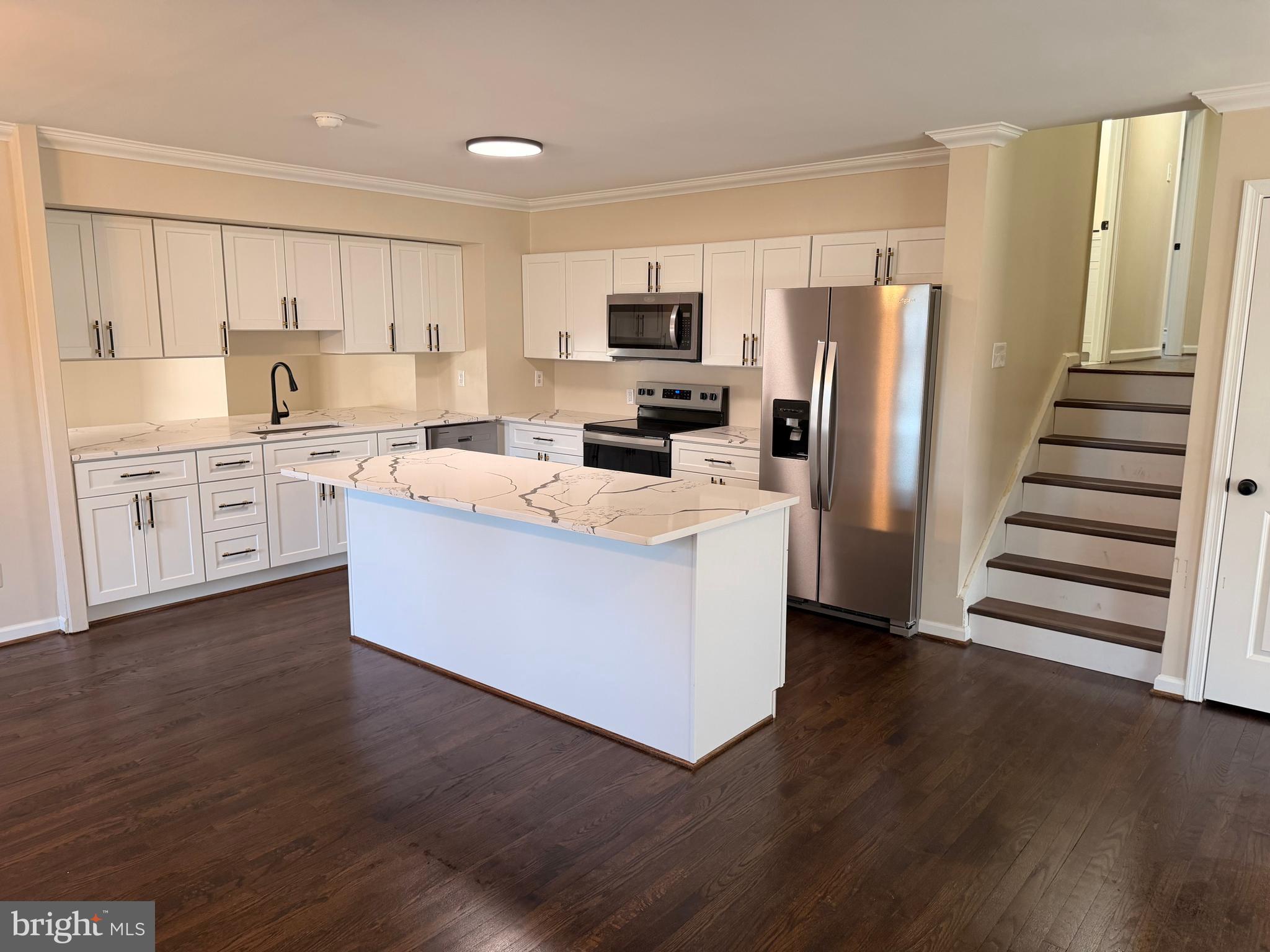 21184 Colton Point Road Avenue, MD 20609 - Photo 8 of 20 a large kitchen with stainless steel appliances granite countertop a stove top oven a refrigerator a sink and dishwasher with wooden floor