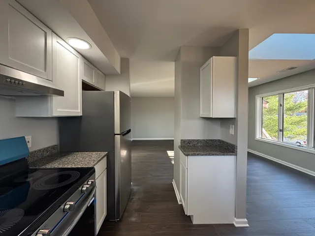 a kitchen with a stove and a refrigerator