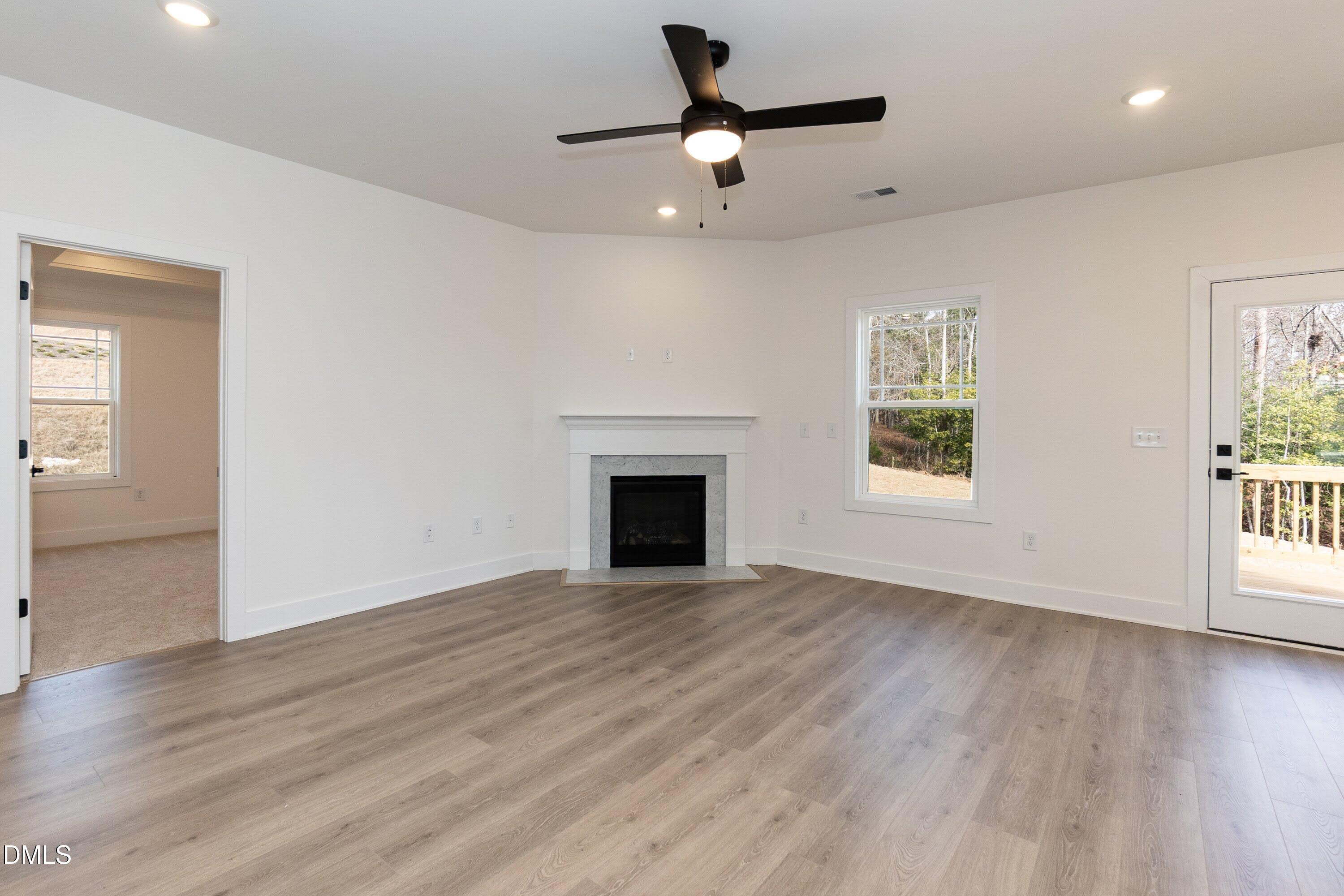42 Braddock Court Garner, NC 27529 - Photo 16 of 56 a view of an empty room with wooden floor and a window