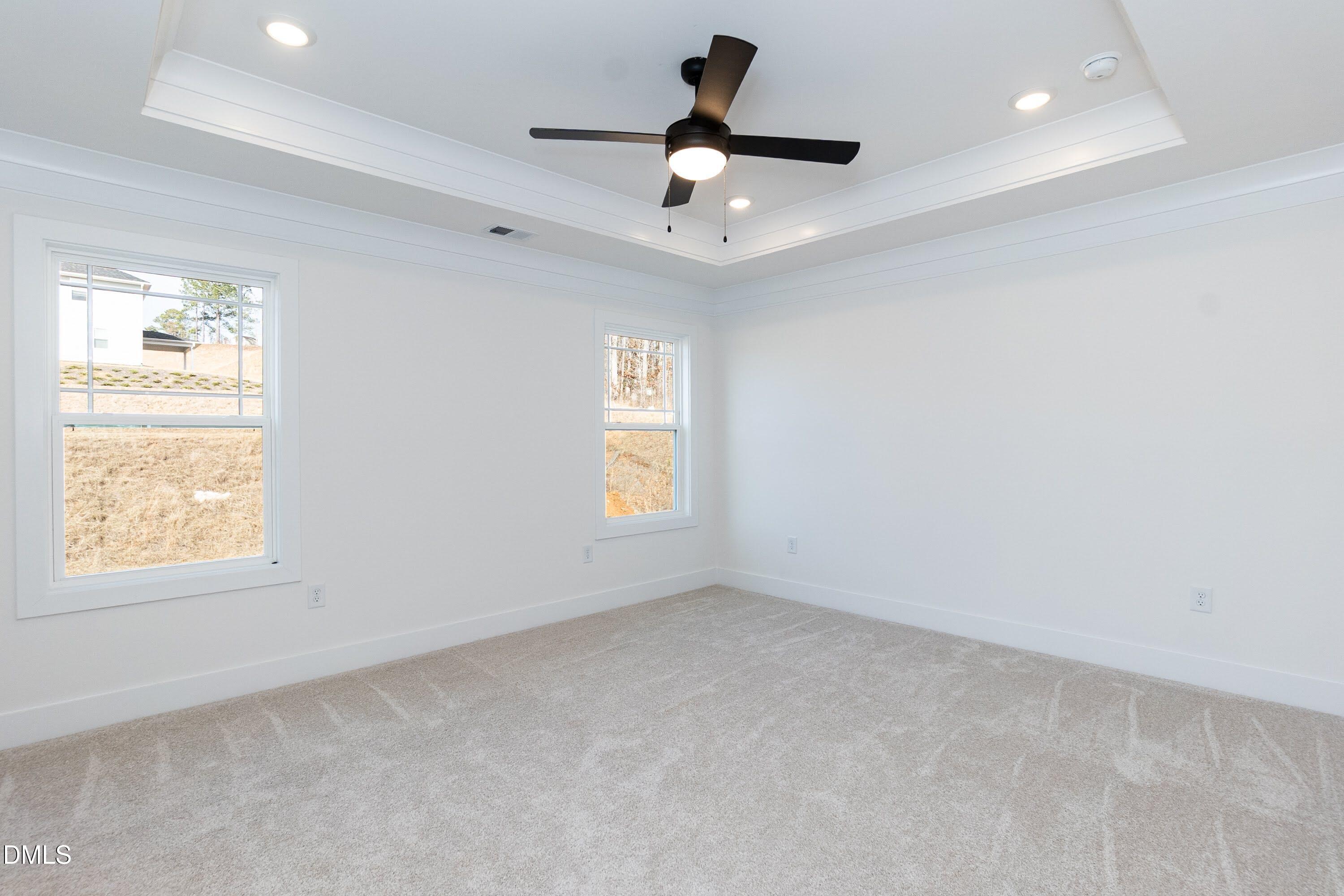 42 Braddock Court Garner, NC 27529 - Photo 18 of 56 an empty room with a window and a fan