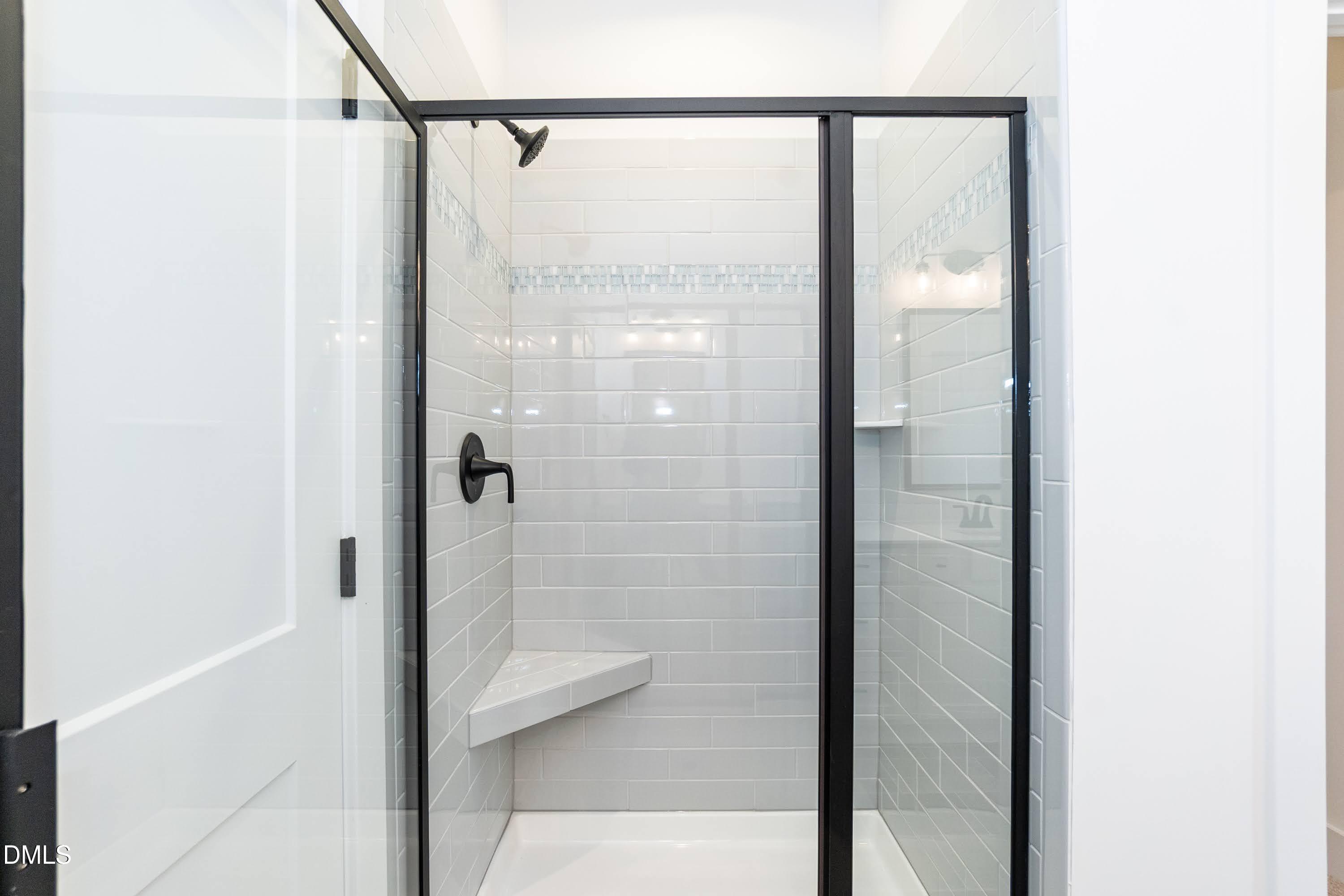 42 Braddock Court Garner, NC 27529 - Photo 22 of 56 a bathroom with a glass shower door