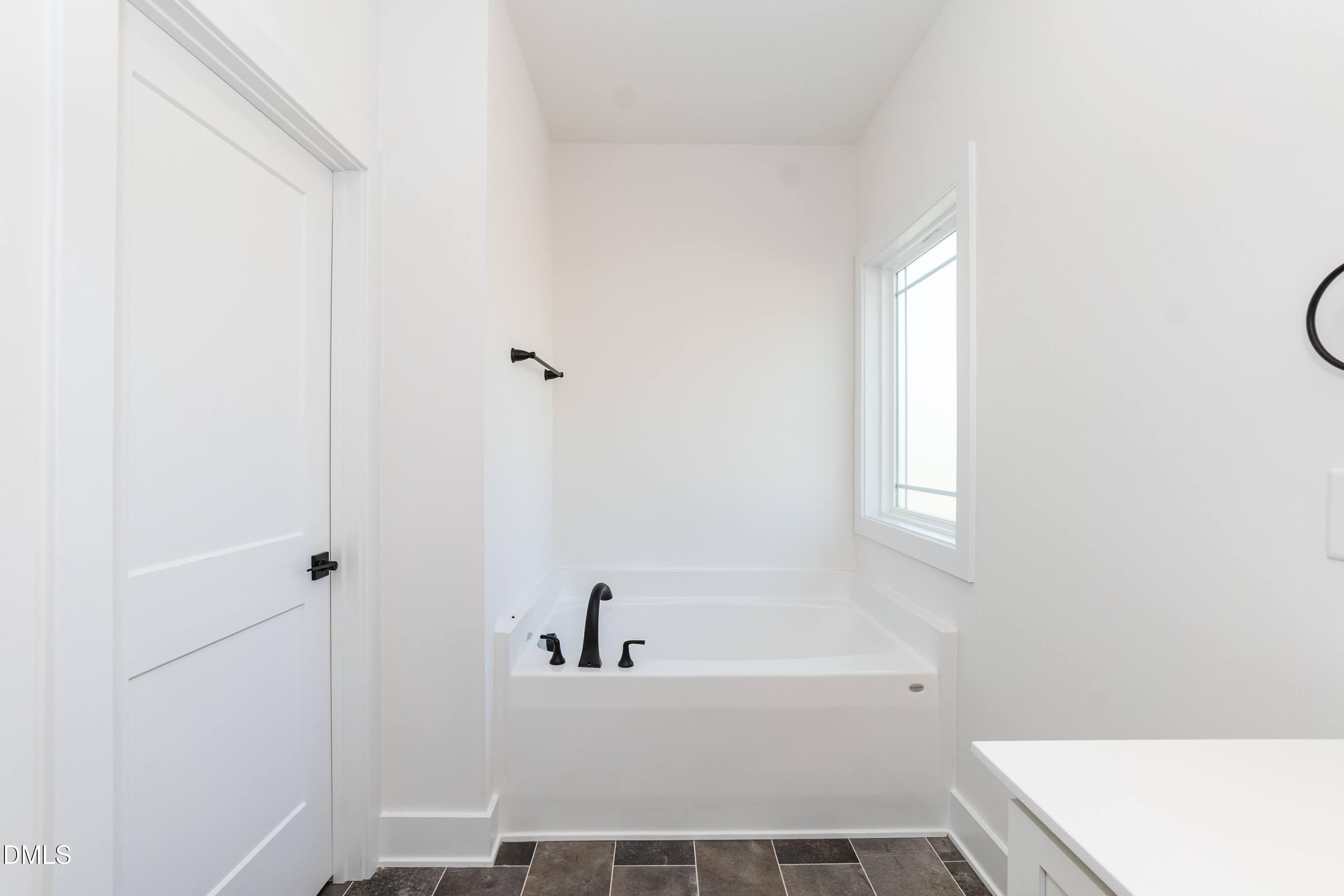 42 Braddock Court Garner, NC 27529 - Photo 23 of 56 a bathroom with a bathtub and shower
