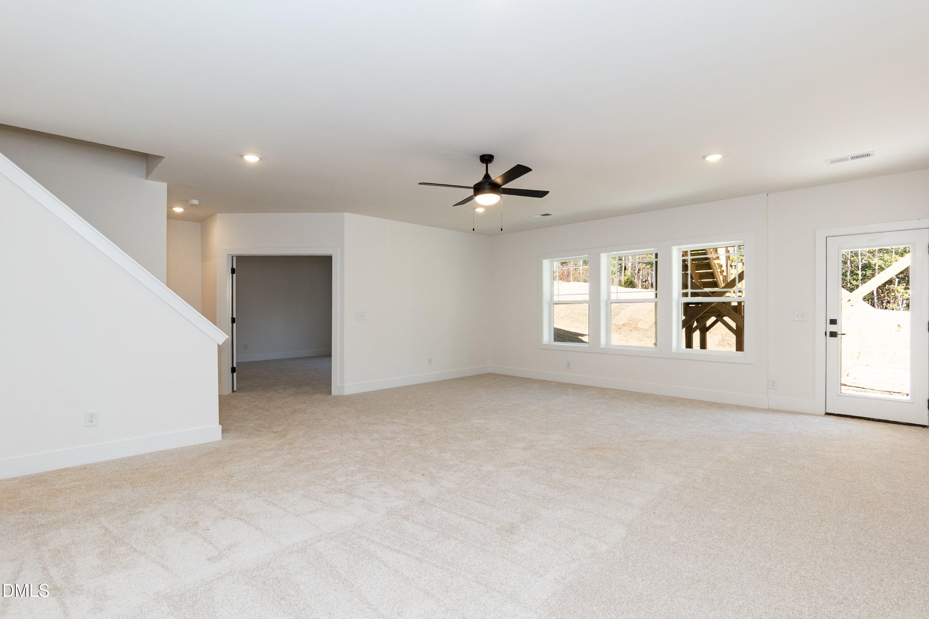 42 Braddock Court Garner, NC 27529 - Photo 40 of 56 an empty room with windows and ceiling fan