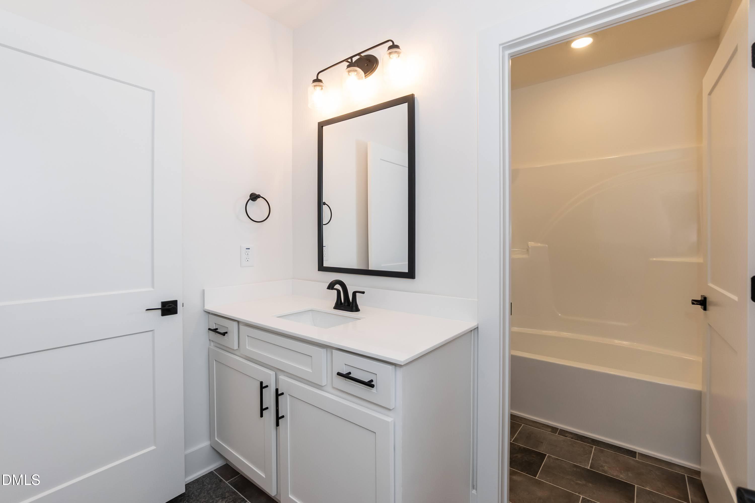42 Braddock Court Garner, NC 27529 - Photo 44 of 56 a bathroom with a sink and a mirror