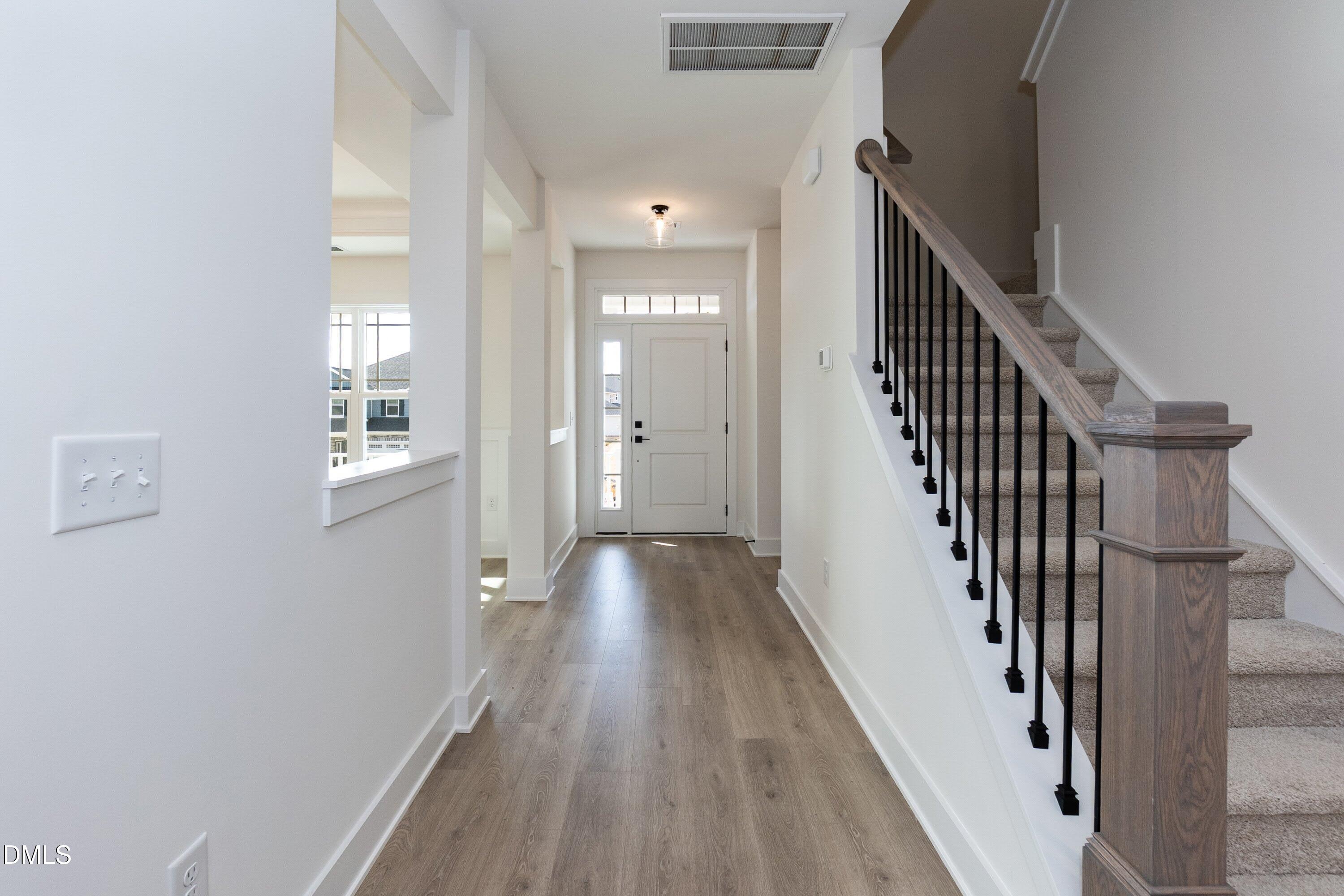 42 Braddock Court Garner, NC 27529 - Photo 8 of 56 a view of a hallway with wooden floor and staircase
