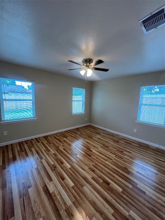 7613 Lady Street Houston, TX 77021 - Photo 12 of 18 a view of empty room with window and wooden floor