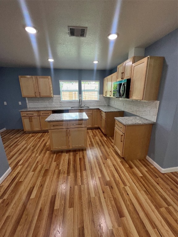 7613 Lady Street Houston, TX 77021 - Photo 7 of 18 a large kitchen with stainless steel appliances a large counter top a stove and a sink