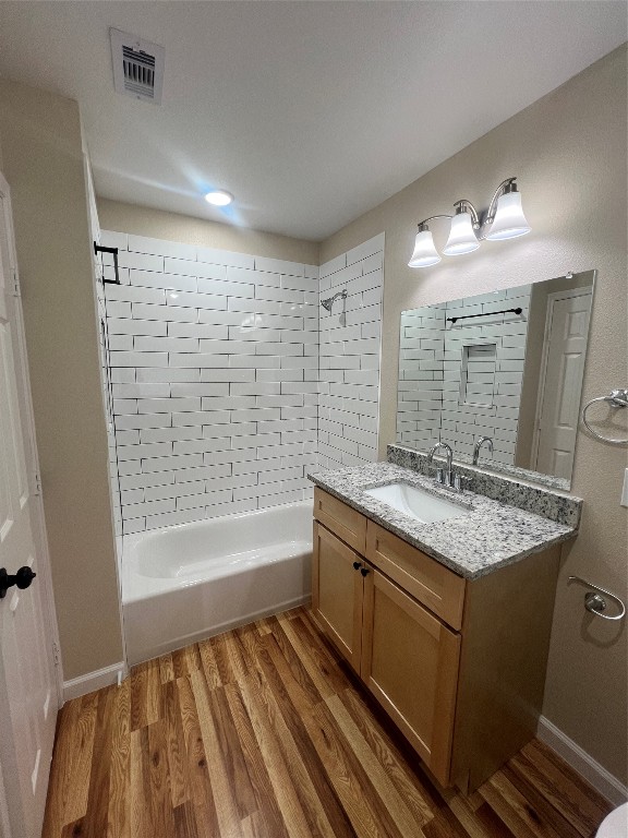 7613 Lady Street Houston, TX 77021 - Photo 9 of 18 a bathroom with a granite countertop sink a toilet a mirror a bathtub and shower