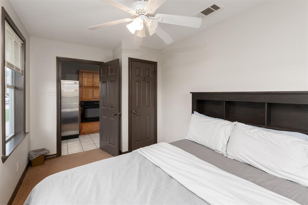 1747 County Road 1785 Yantis, TX 75497 - Photo 31 of 40 a bedroom with a bed and a chandelier