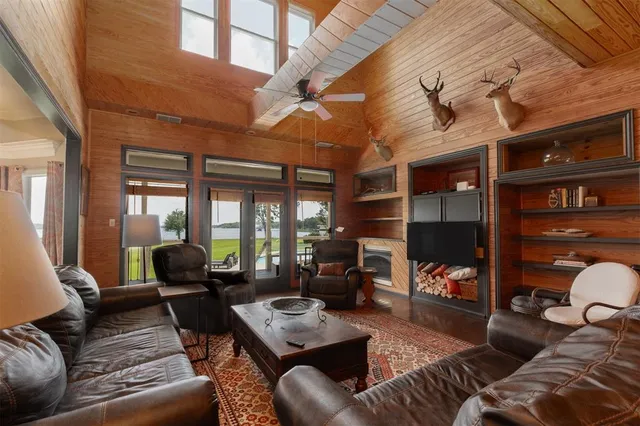 a living room with furniture a fireplace and a large window