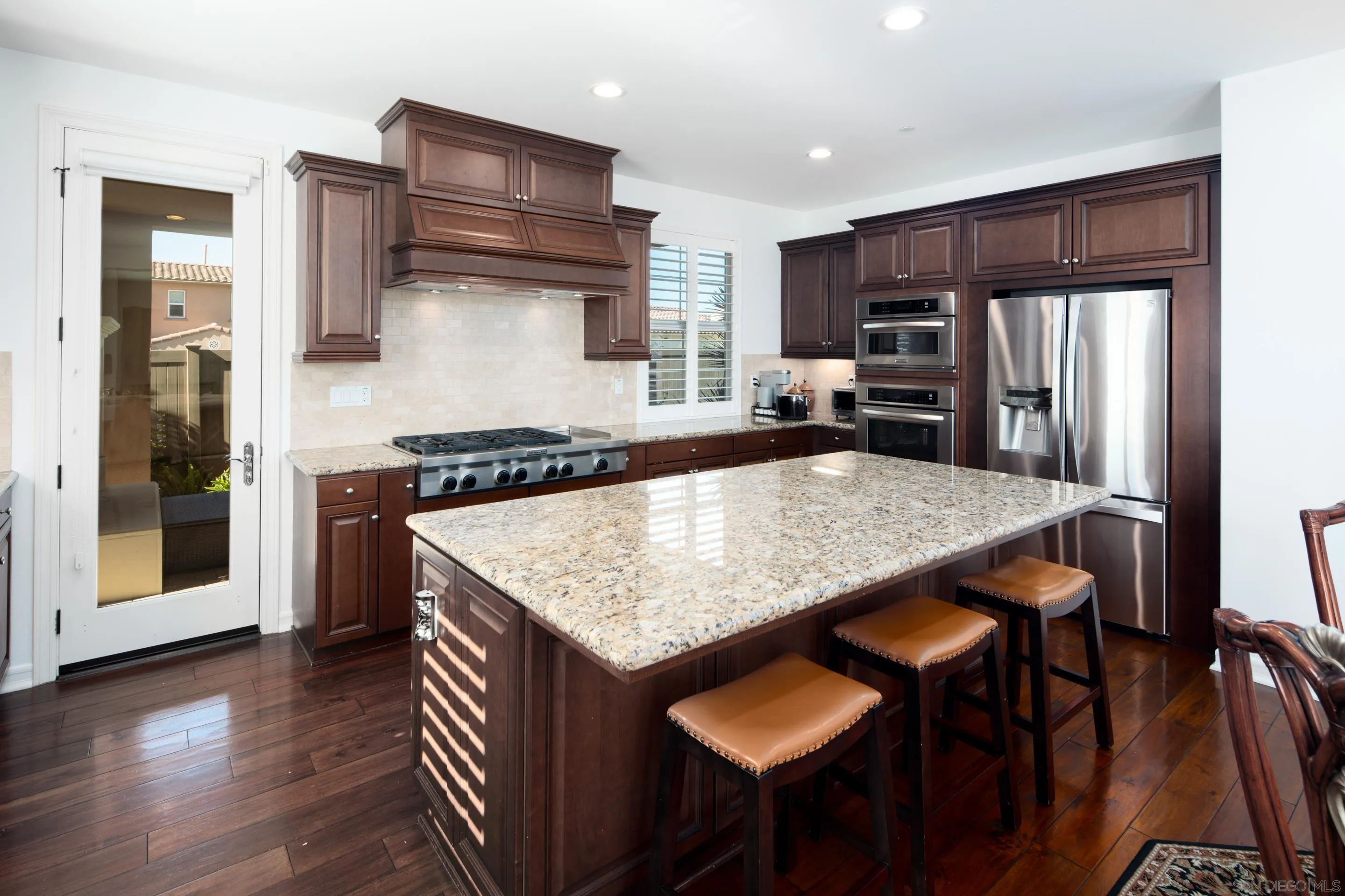 931 Bluejack Road Encinitas, CA 92024 - Photo 14 of 37 a kitchen with a table and chairs in it