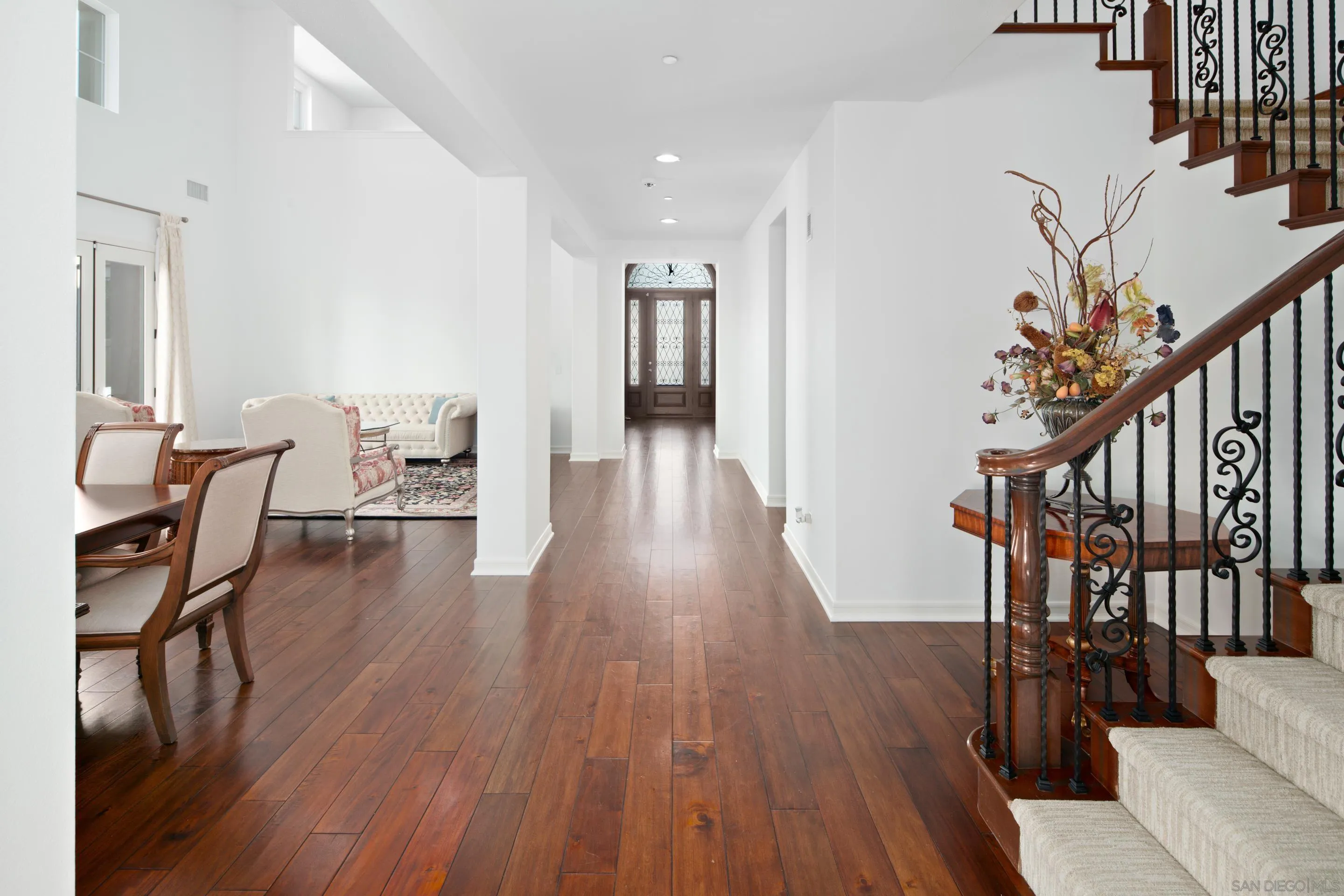 931 Bluejack Road Encinitas, CA 92024 - Photo 10 of 37 a furnished dining room with wooden floor and stairs