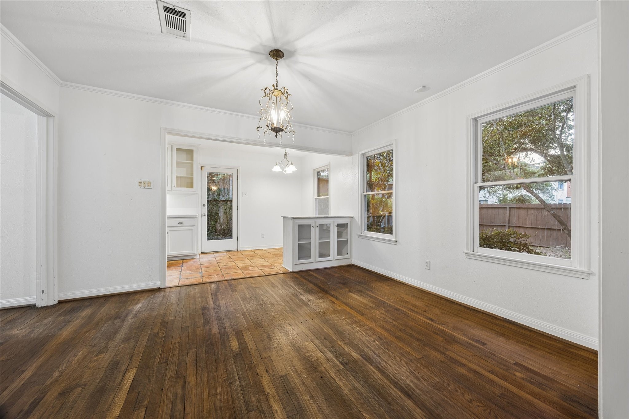 1931 Bissonnet Street Houston, TX 77005 - Photo 11 of 22 a view of an empty room with wooden floor and a window