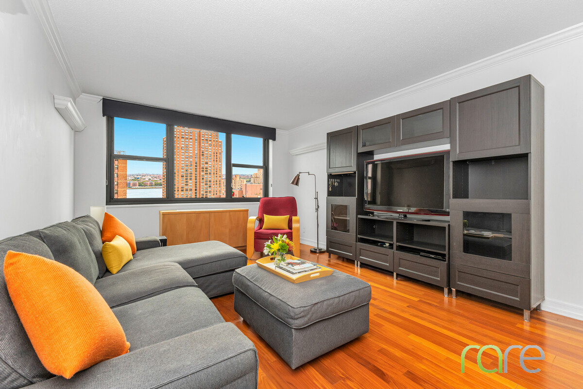 340 East 93rd Street, Unit 23G Manhattan, NY 10128 - Photo 1 of 16 a living room with furniture and a flat screen tv