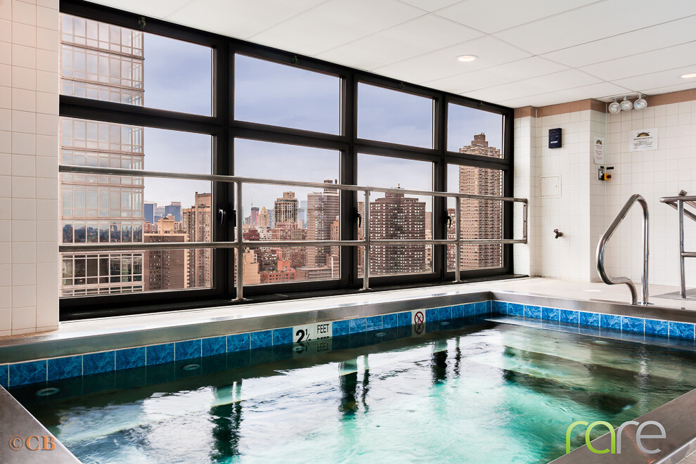 340 East 93rd Street, Unit 23G Manhattan, NY 10128 - Photo 10 of 16 a living room filled with furniture and a window