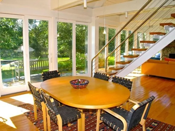 a view of a dining room with furniture a chandelier and wooden floor