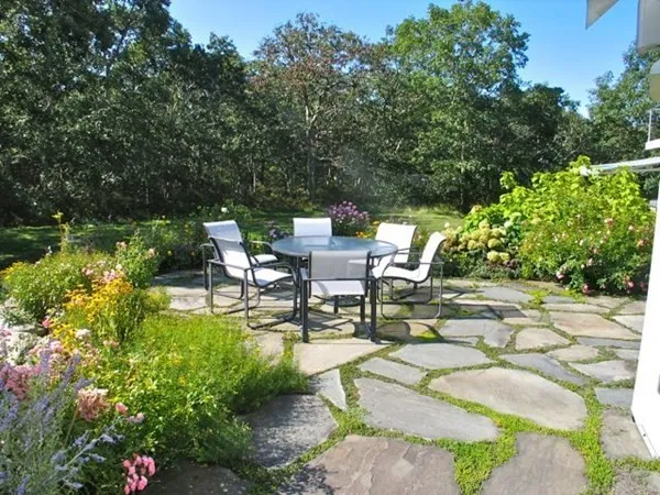 a swimming pool with outdoor seating and garden