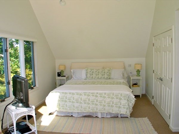 2 Nonamesset Road Edgartown, MA 02539 - Photo 23 of 36 a bedroom with a bed and wooden floor