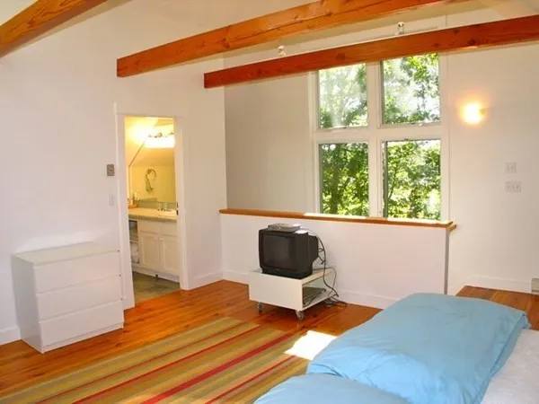 a room with a flat screen tv and a window