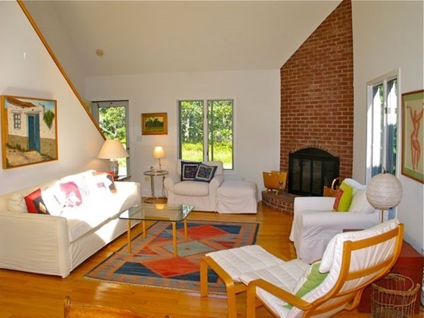 2 Nonamesset Road Edgartown, MA 02539 - Photo 7 of 36 a living room with fireplace furniture and a wooden floor