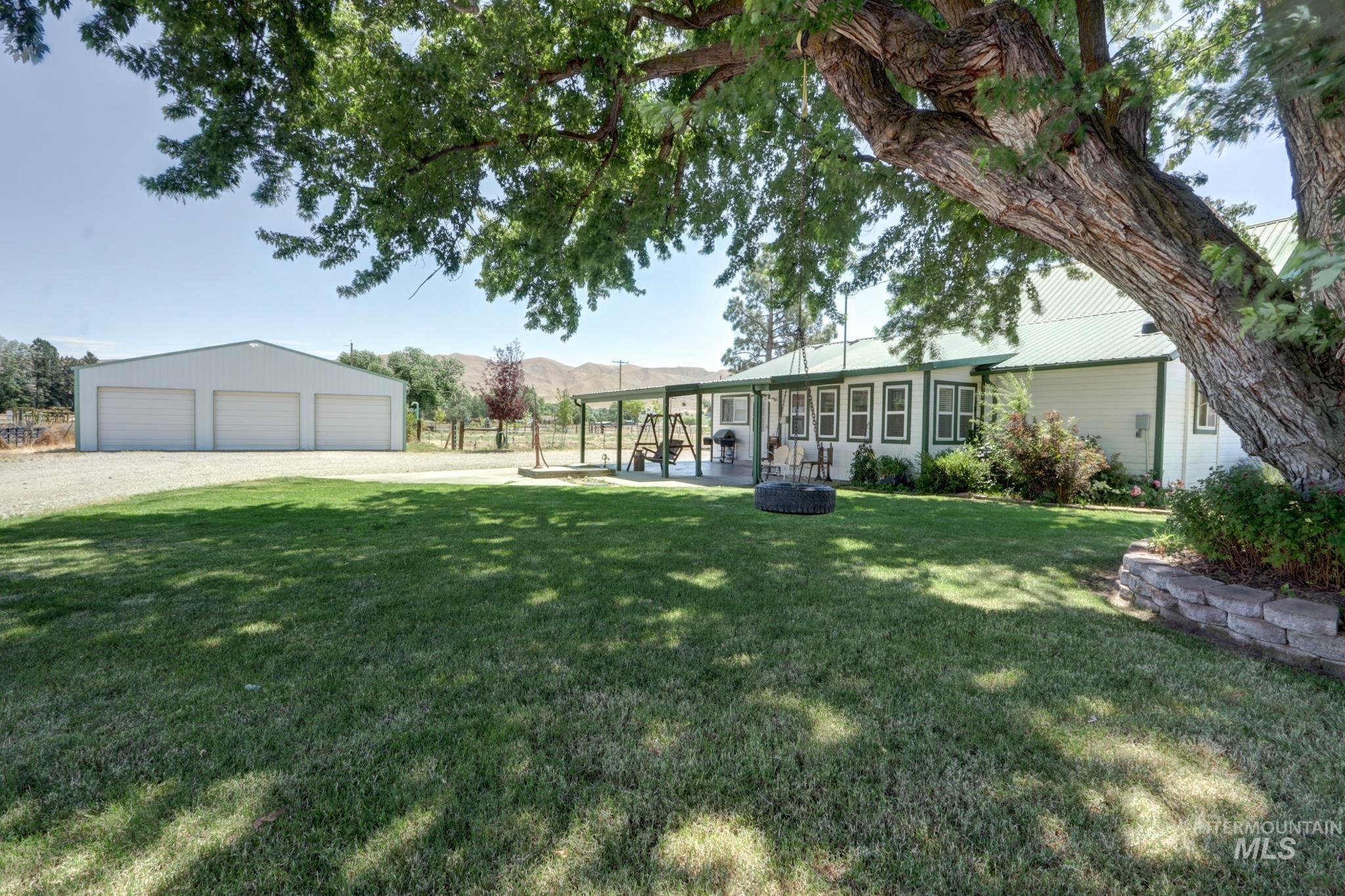 2528 Waterwheel Road Emmett, ID 83617 - Photo 5 of 50 White-sided residence with a vibrant green metal roof