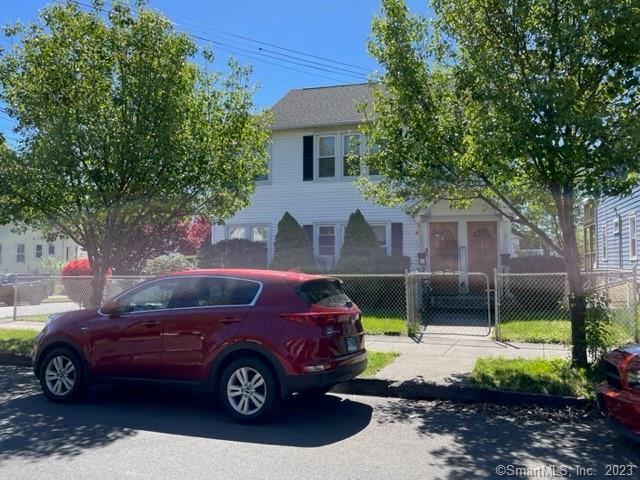 135 Wade Street Bridgeport, CT 06604 - Photo 1 of 1 a front view of a house with a garden and parking space