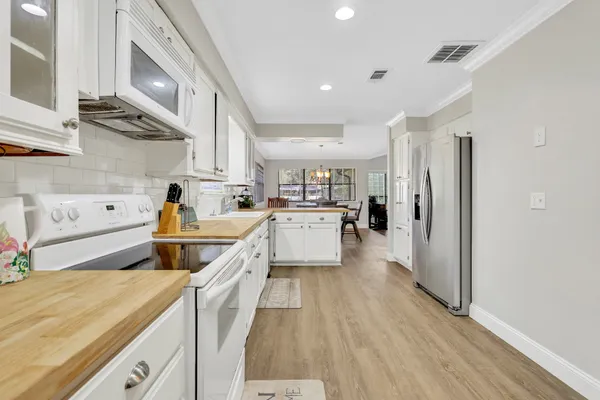 a kitchen with stainless steel appliances a stove a sink and a refrigerator