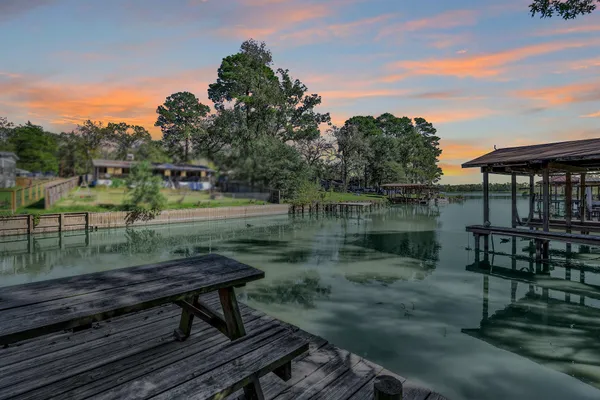 a wooden bench sitting next to a lake