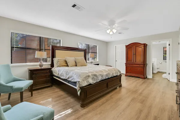 a bedroom with a large bed and a large window