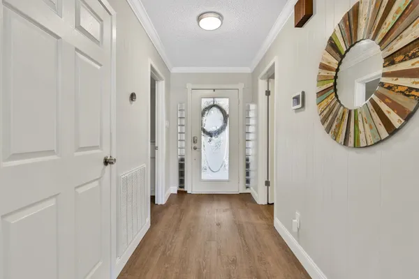 a view of a hallway with wooden floor