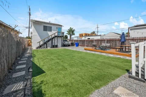 a view of a house with a yard and furniture