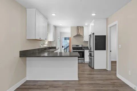 a kitchen with stainless steel appliances granite countertop a refrigerator a stove a sink and a microwave