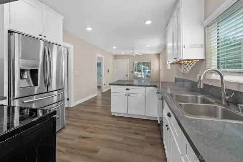 a kitchen with a sink stainless steel appliances and window