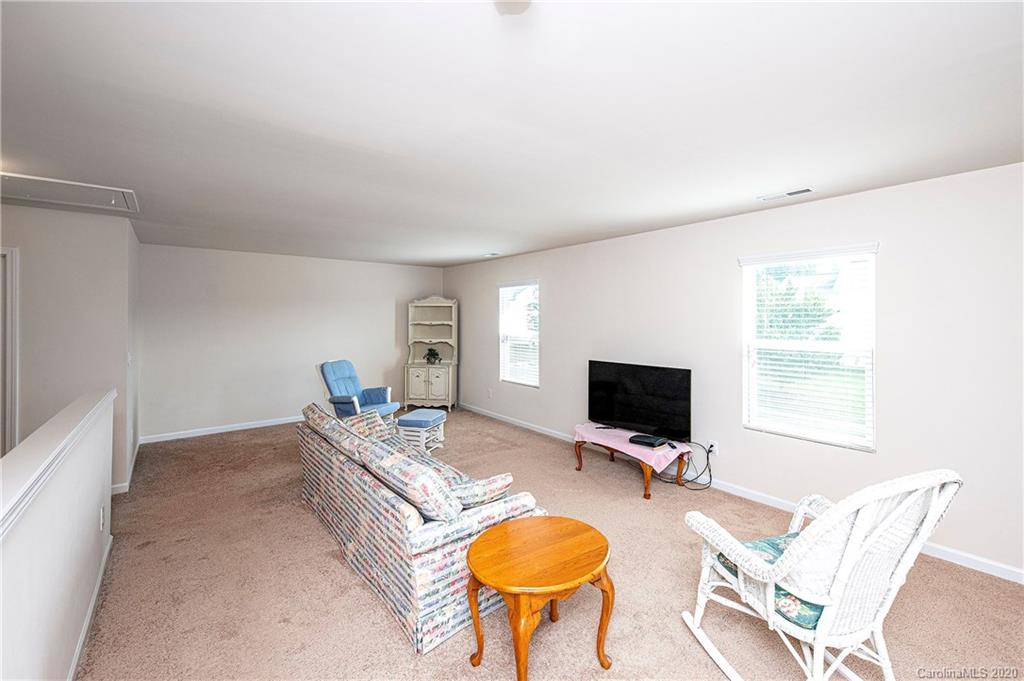 9915 Paper Tree Road Charlotte, NC 28227 - Photo 16 of 35 a living room with furniture and a flat screen tv
