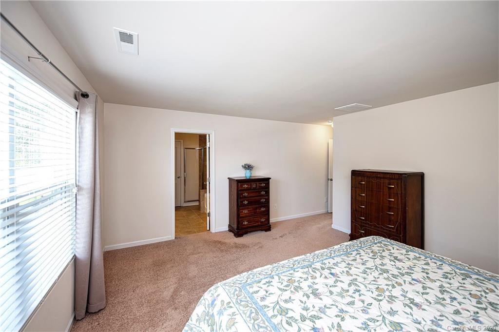 9915 Paper Tree Road Charlotte, NC 28227 - Photo 18 of 35 a bedroom with a large bed and dresser