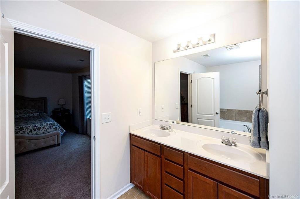 9915 Paper Tree Road Charlotte, NC 28227 - Photo 21 of 35 a spacious bathroom with a double vanity sink and a mirror