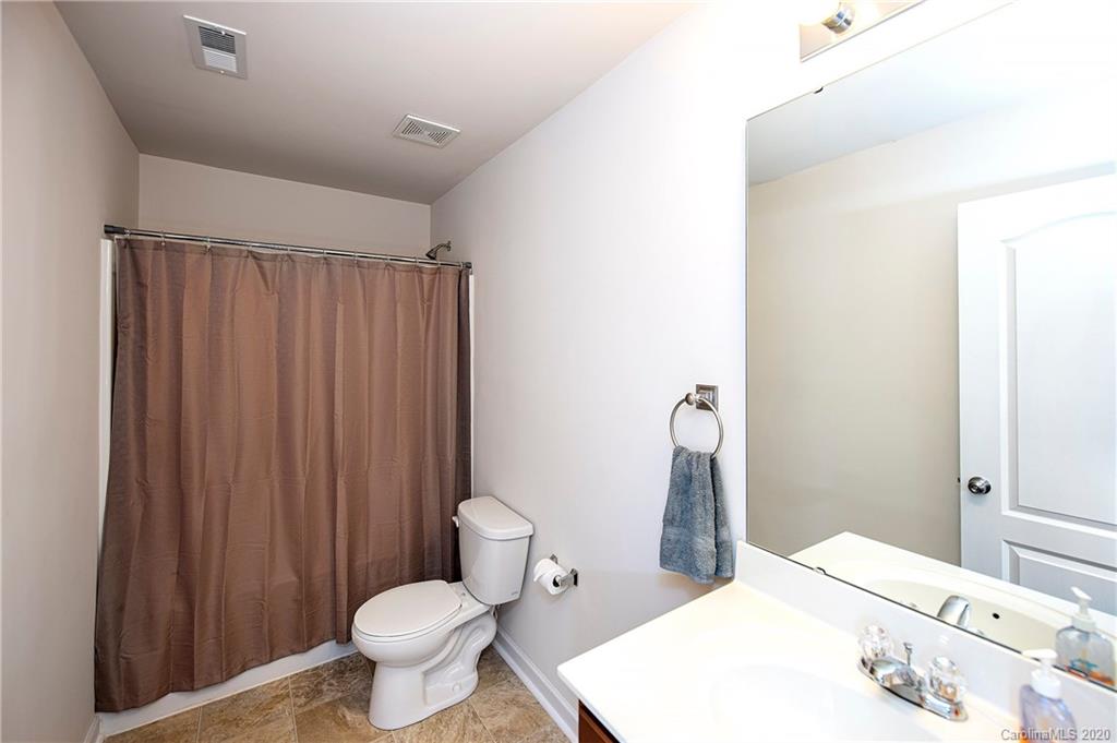 9915 Paper Tree Road Charlotte, NC 28227 - Photo 24 of 35 a bathroom with a sink a toilet and shower curtain